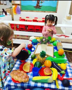 Teacher guiding preschool children during learning time