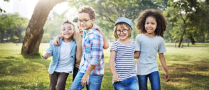 Group of diverse children playing together in a sunny park