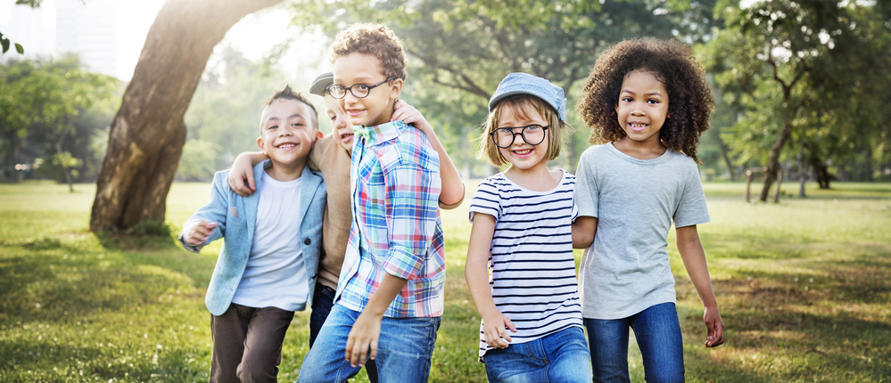 Group of diverse children playing together in a sunny park