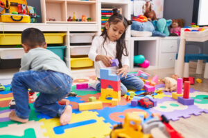 preschoolers stacking foam blocks on puzzle mat