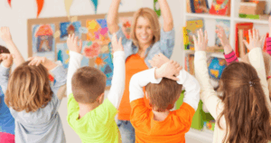Toddlers participating in an early learning activity at Grateful Hearts Preschool Henderson with a teacher leading the class