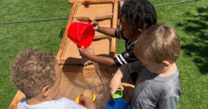 Children at Grateful Hearts Preschool participate in outdoor water play activities that support social development and early learning in Las Vegas.