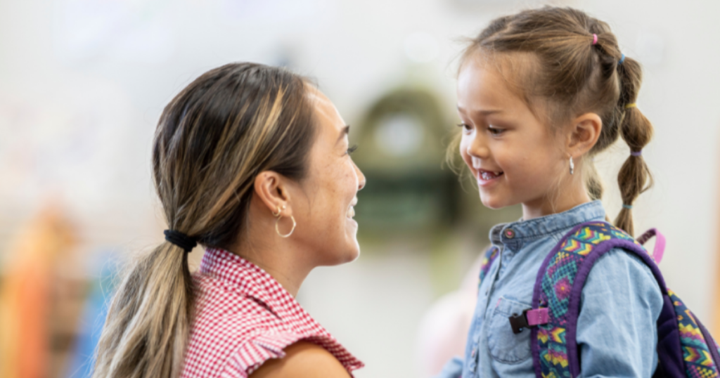 Smiling parent and child greeting at preschool helps reduce separation anxiety with supportive routines in Las Vegas
