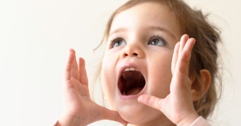 Toddler developing language skills at the best preschool in Las Vegas through expressive communication and early learning activities